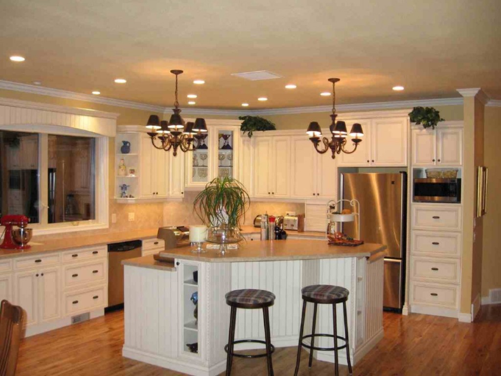 L Shaped Kitchen Layouts With Island with white island and cabinet with drawer and two chandlier