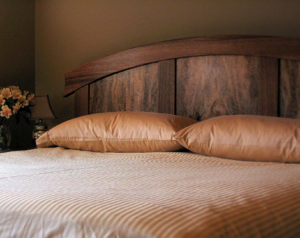 Modern wood Headboard Styles Ideas in eleagnt bedroom with flower vase on bedside table
