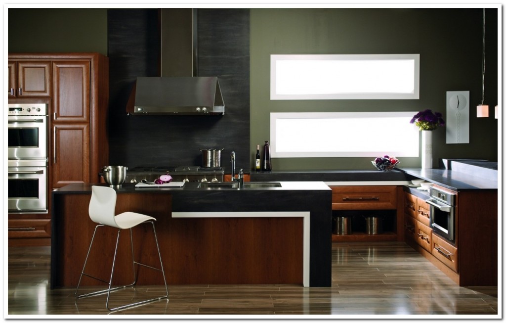 small Kitchen with brown Cabinet and island Color with black backsplash and countertop and white chair