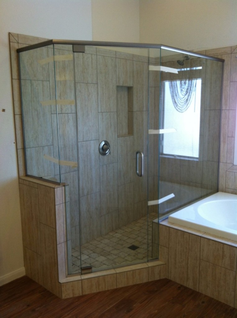 Sleek Laminate Floor With Semi Frameless Shower door room with tile wall and corner bathtub with small window