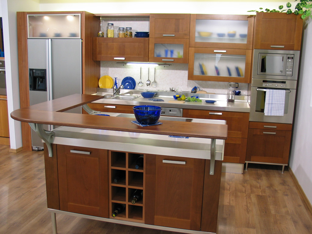 Small U Shaped Kitchen Layouts with bar and brown cabinet and laminate wood flooring