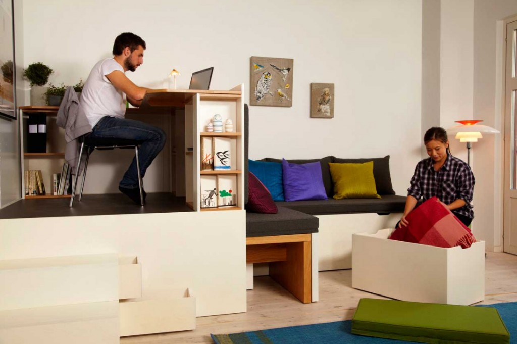 Small Studio Apartment living room and level home office with black sofa l shaped simple desk
